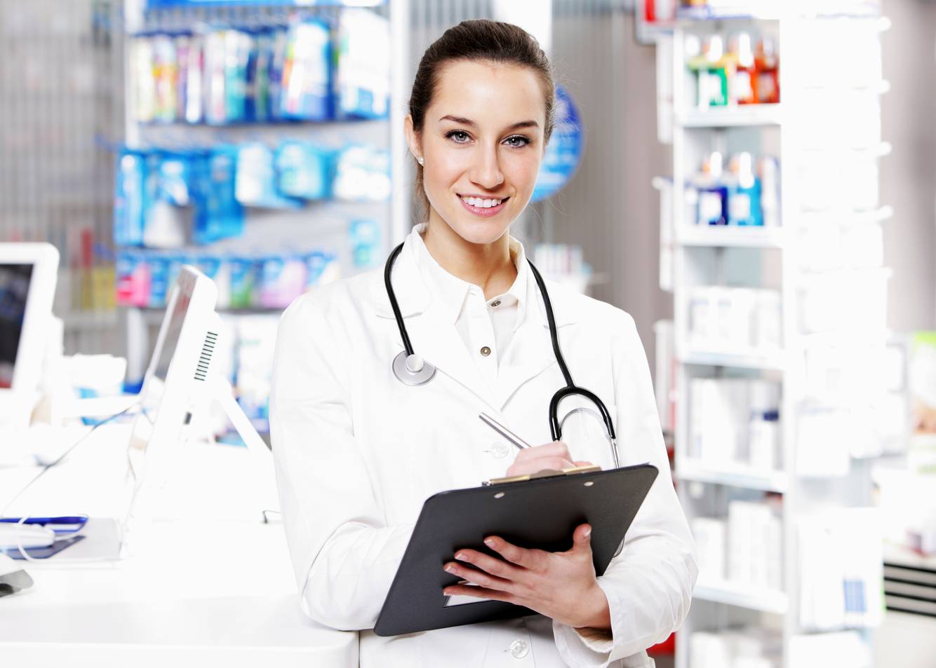 Female pharmacist writing on a clipboard Women’s Health