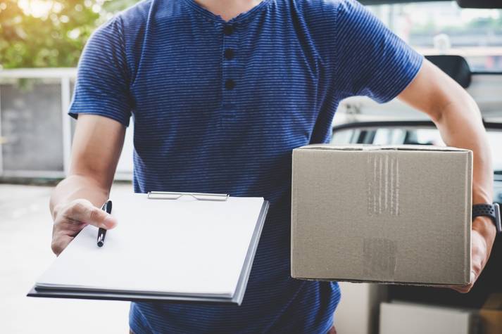 Delivery driver handing over a package Delivery