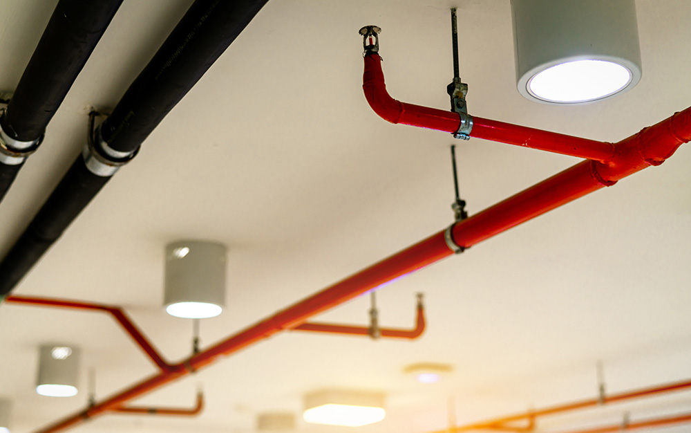 Red pipe sprinkler system attached to ceiling