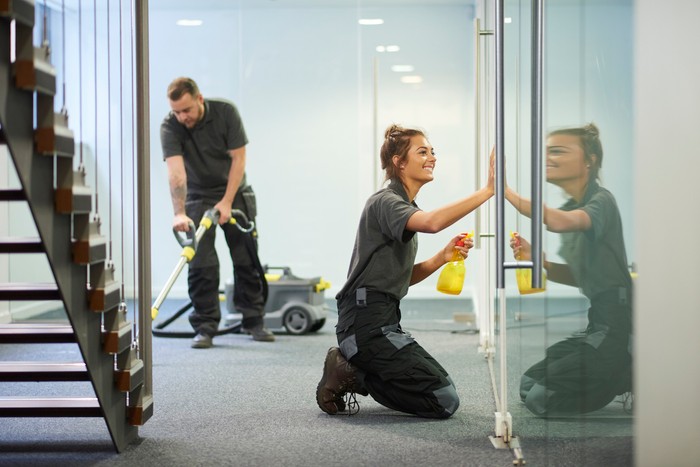 IntegriServ Commercial Cleaning Systems Employees cleaning the floors and doors
