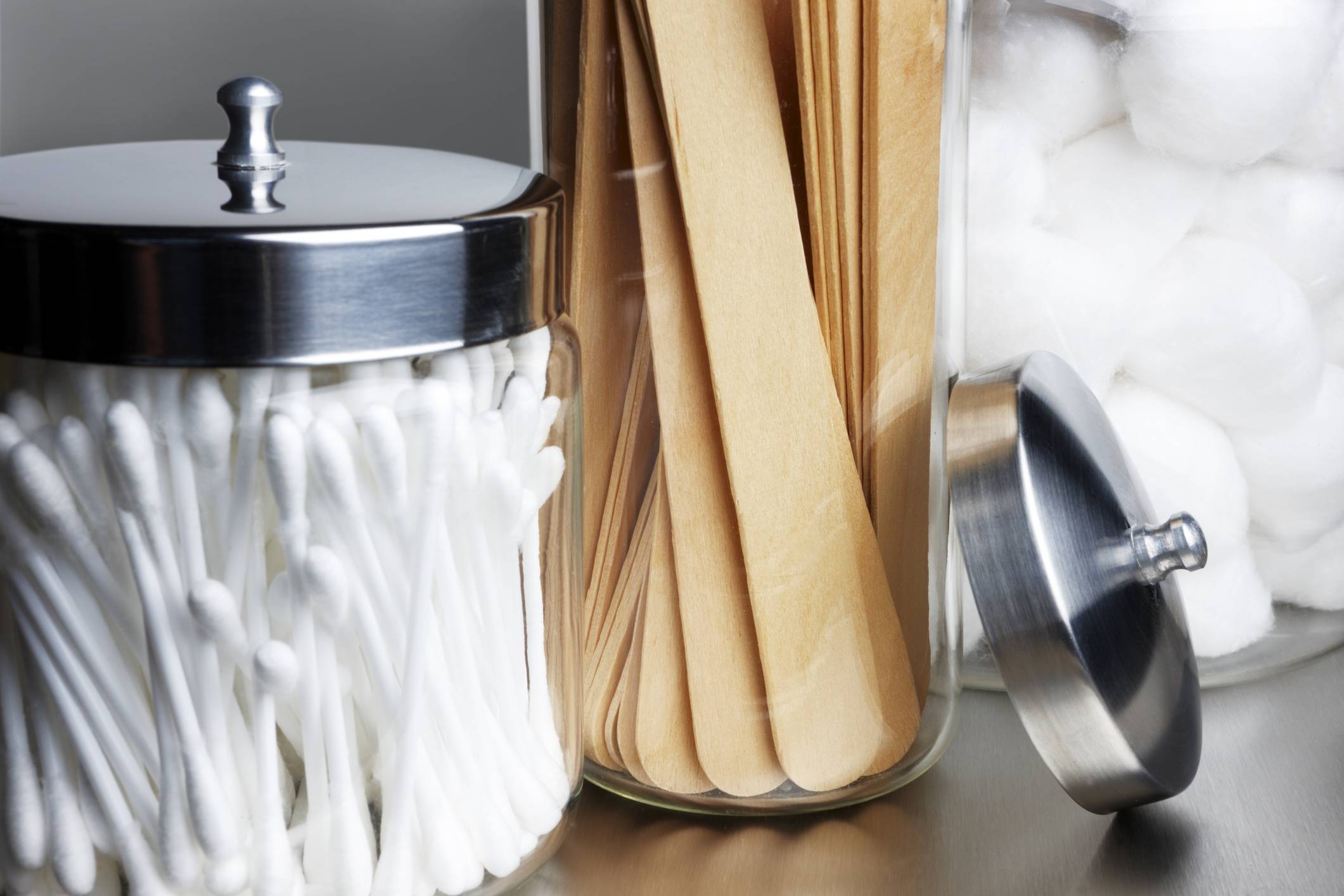 An image of a jar full of q-tips sitting next to a jar full of popsicle sticks. Physician Office Supplies