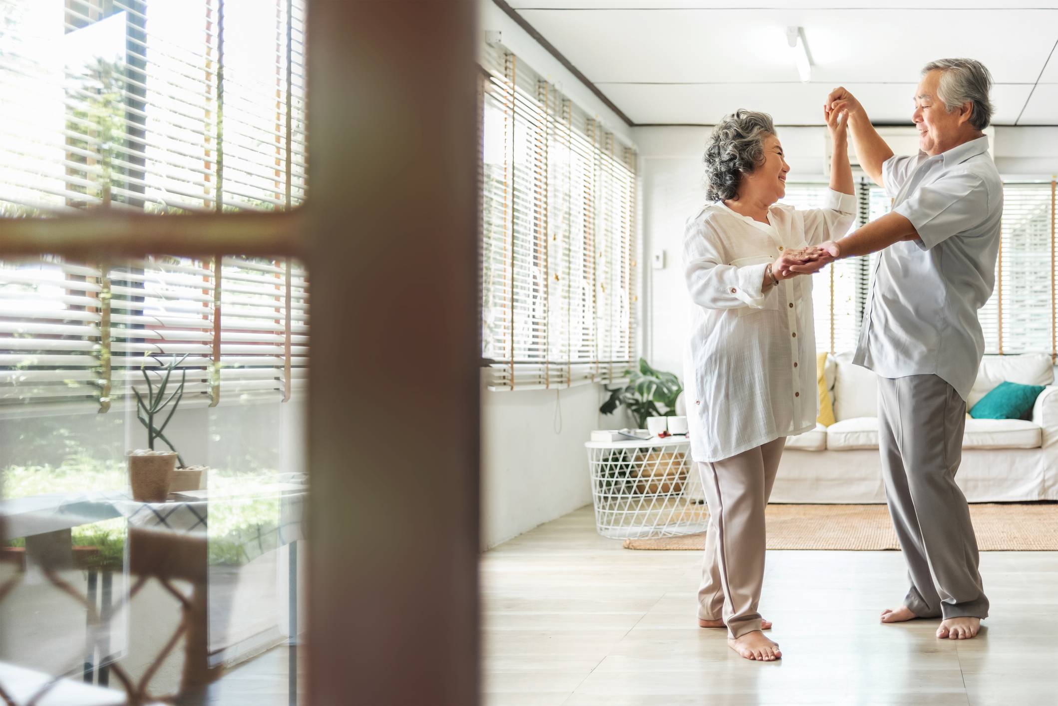 Image of an older couple dancing in their livingroom Medicare Open Enrollment