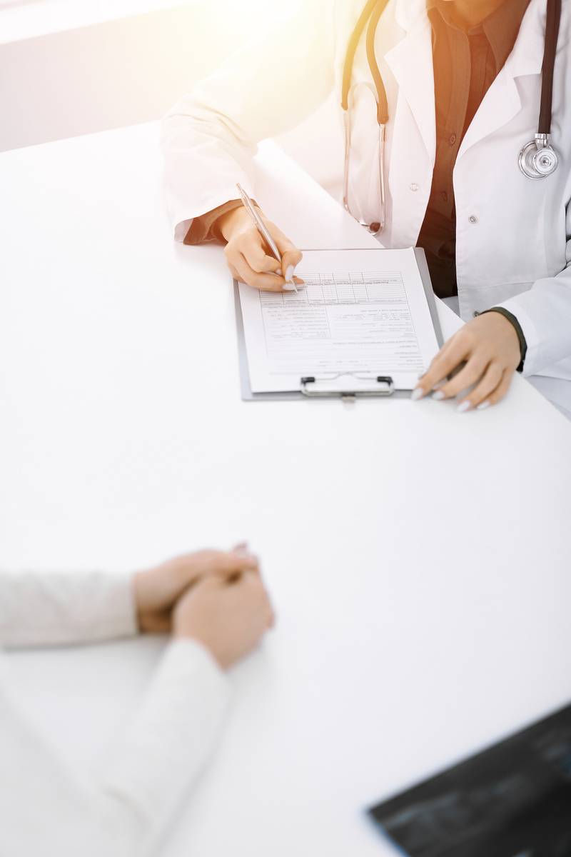 Doctor with questions on a clipboard Doctor with a questionare on a clipboard