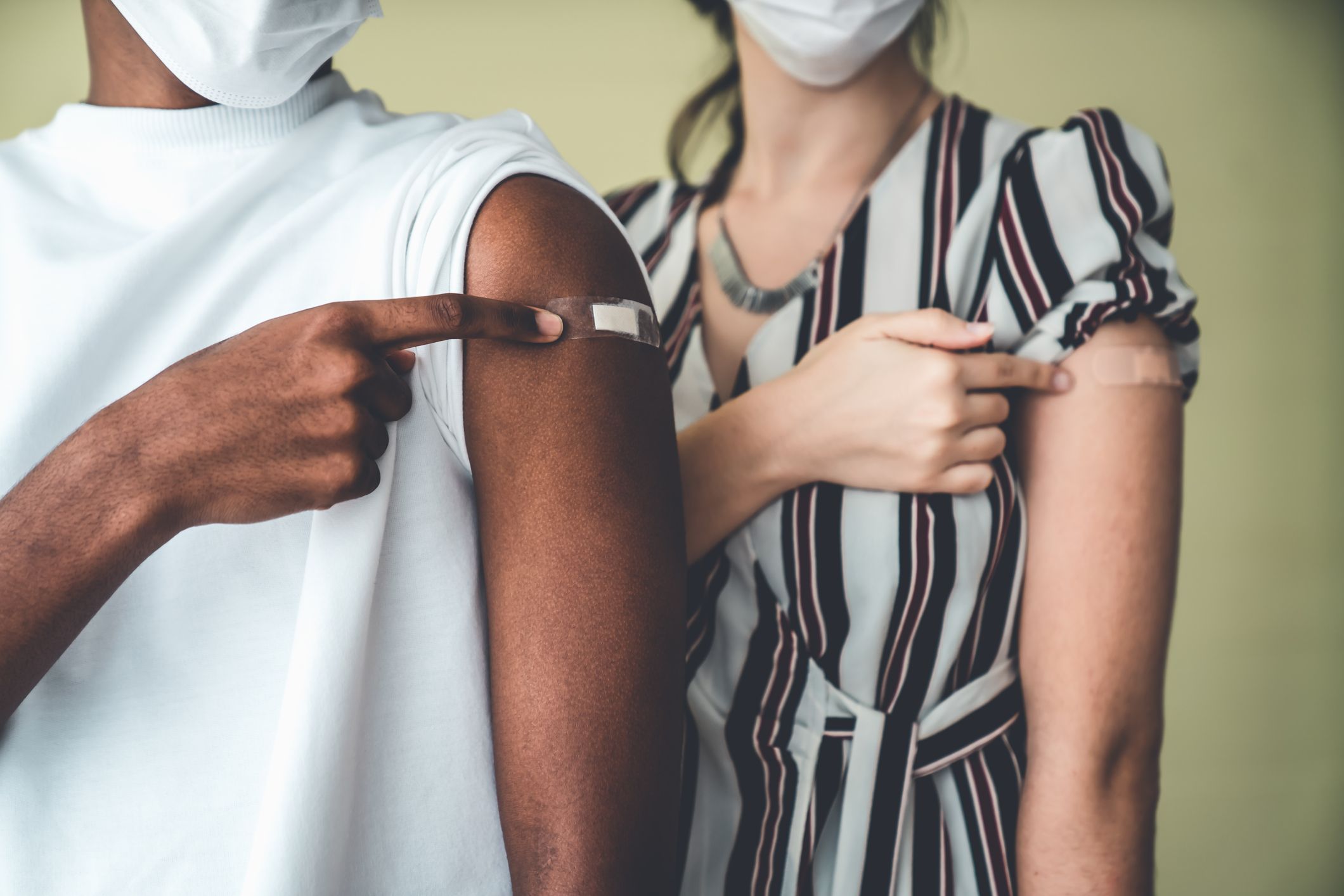 Image of two person showing their vaccinations Immunizations