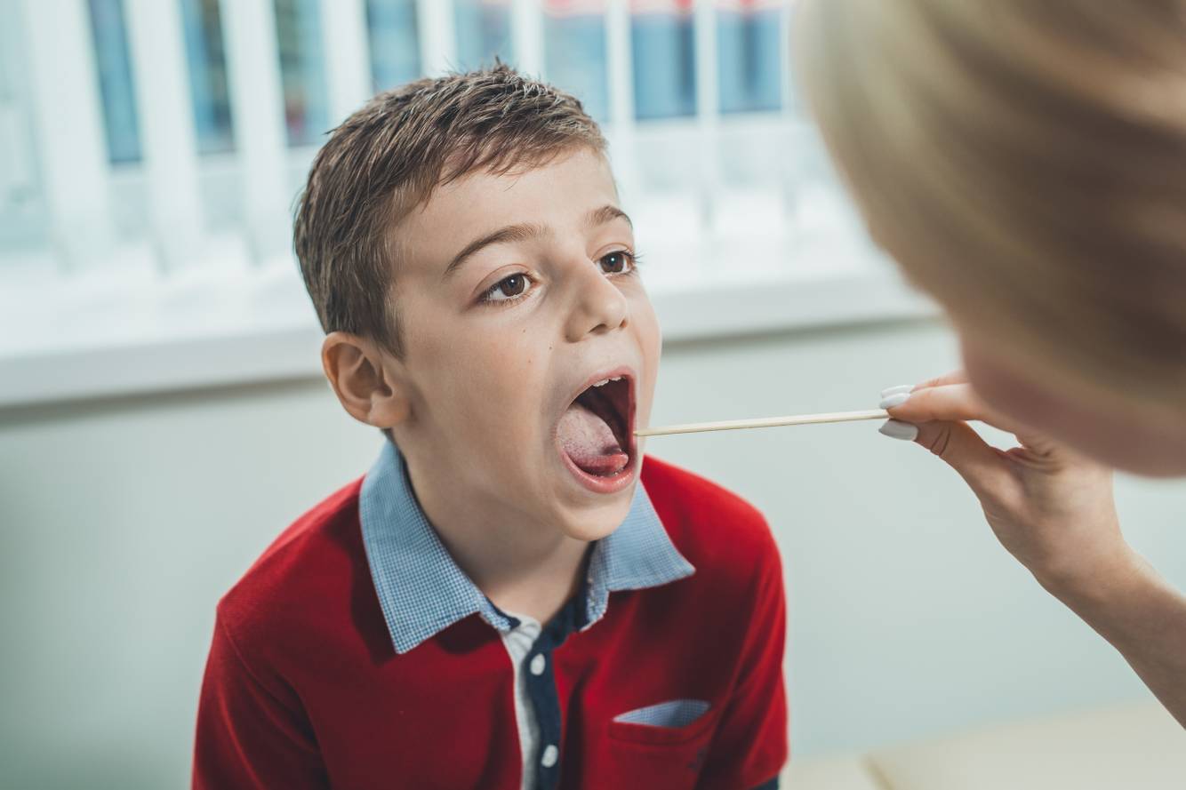 Child receiving a strep test Flu & Strep Testing