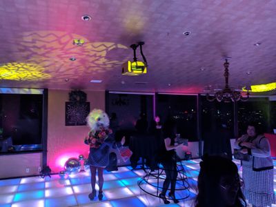 Party attendees dancing on a lit-up dance floor