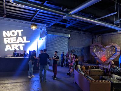 An image of the Not Real Art party with a custom Not Real Art Gobo 