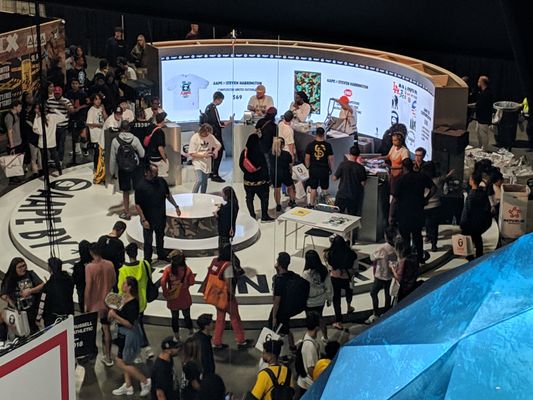 Trade show booth at ComplexCon with curved LED video wall display