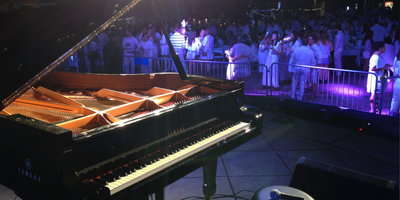 A large Yamaha piano on stage at a concert