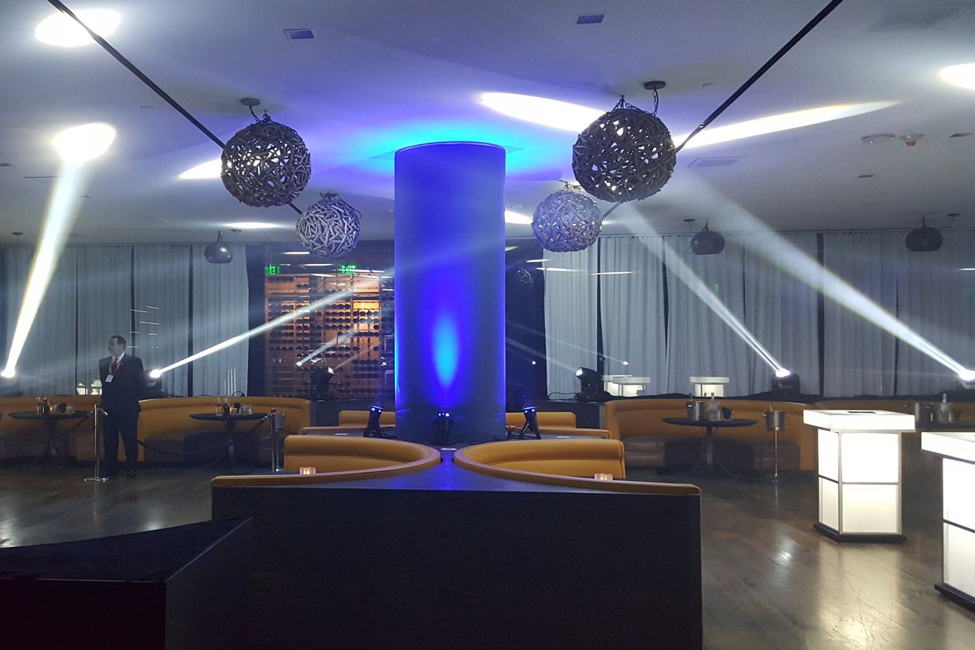 A lounge area at an event in the Sofitel Hotel with moving lights around the space