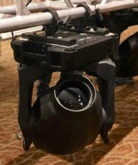 A moving light rigged to a truss at a corporate conference