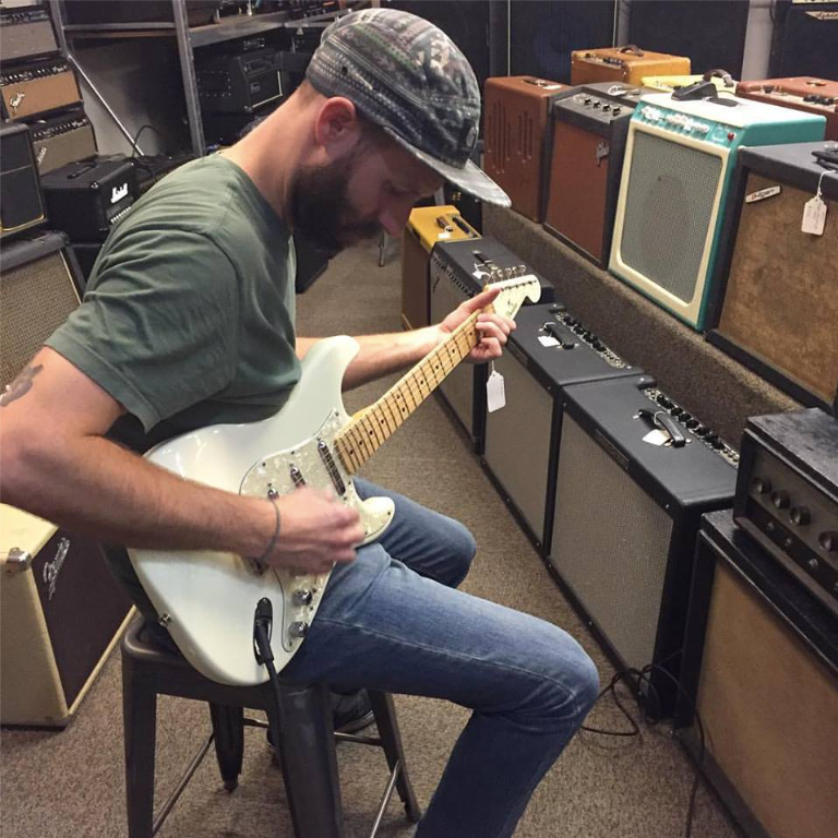 An image of Joel Dodson playing a Fender guitar