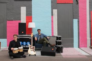 Joel and Conor in front of a mural in St. Louis