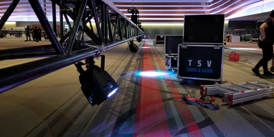 An image of an LED light rigged on a truss