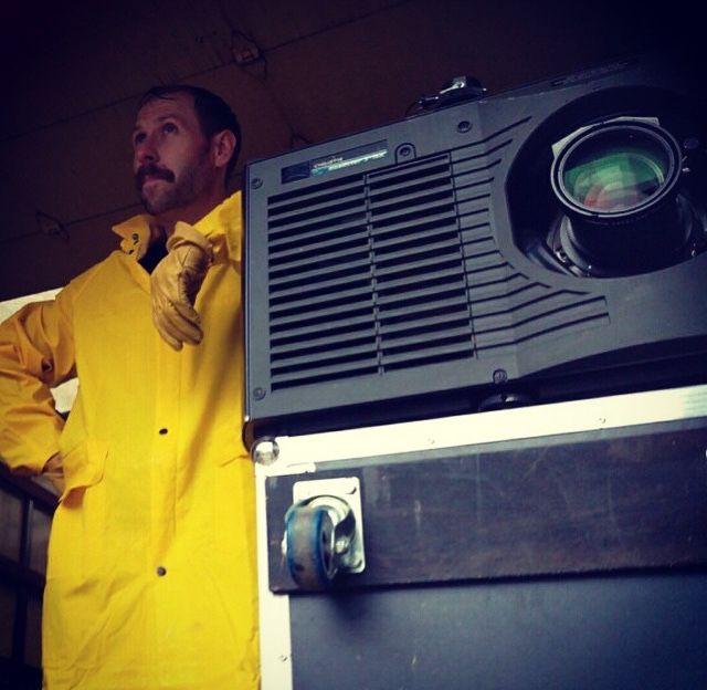 An image of Joel Dodson of TSV Sound & Vision in a yellow raincoat at an event in St. Louis