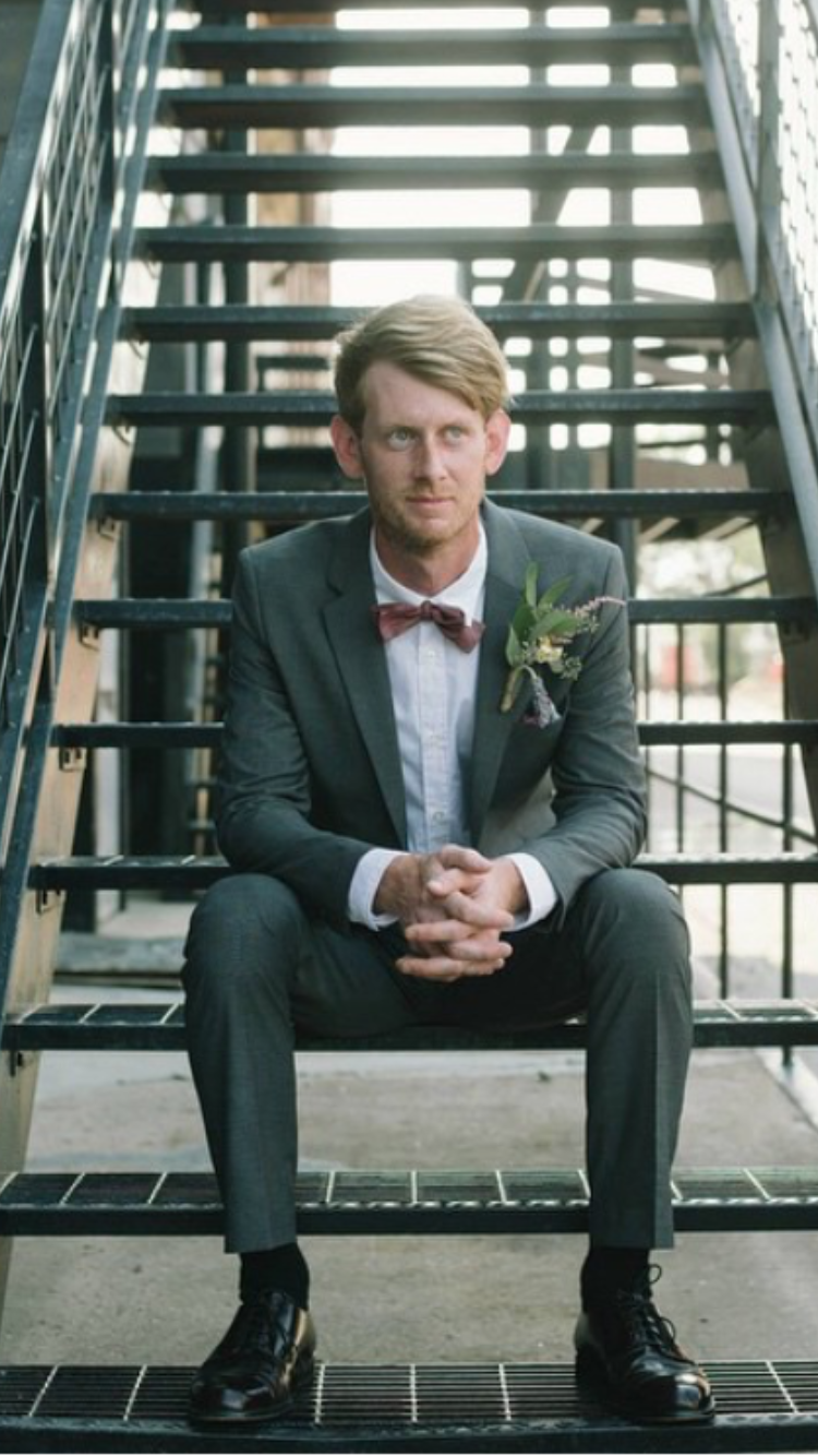 An image of Andrew Carter sitting on a staircase