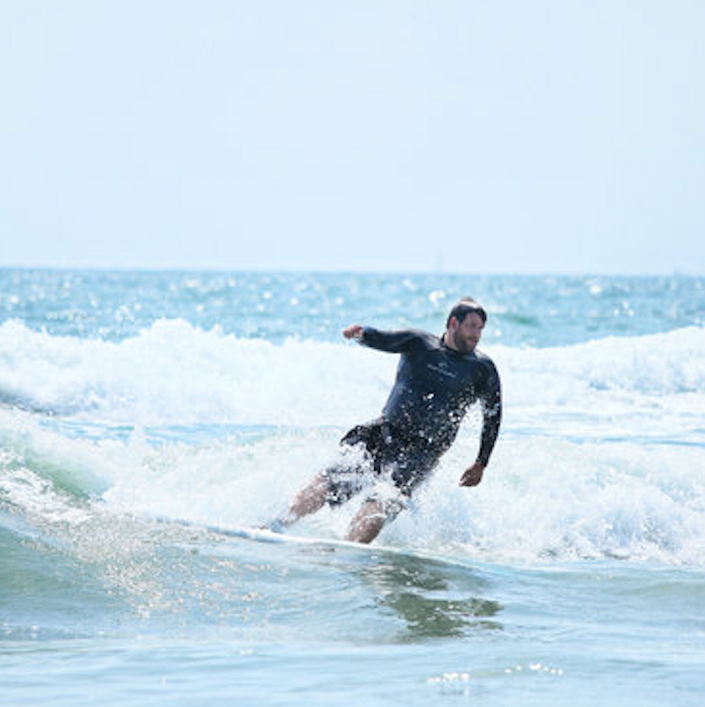 An image of Collin Styles surfing