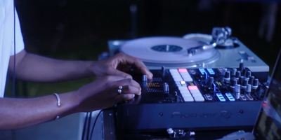  A DJ spinning at a party on Pioneer equipment