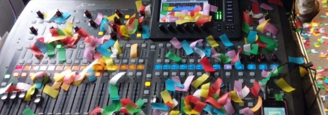 A small audio mixer with confetti on it 