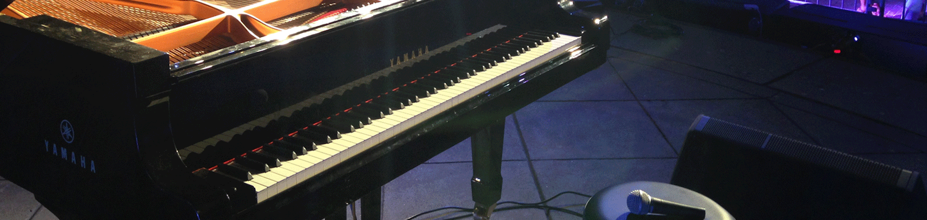 Close up of a Yamaha piano on stage