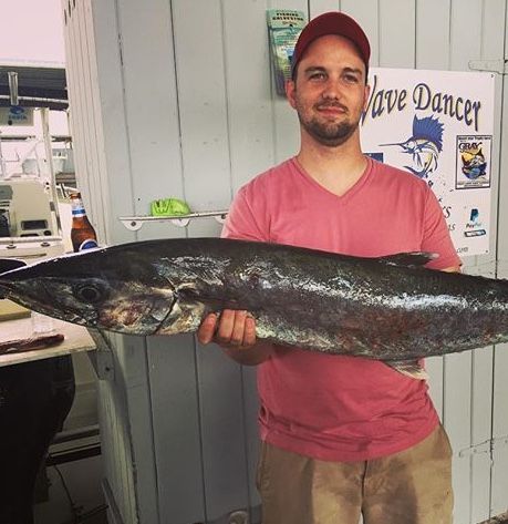 An image of Adam Kendrick holding a large fish