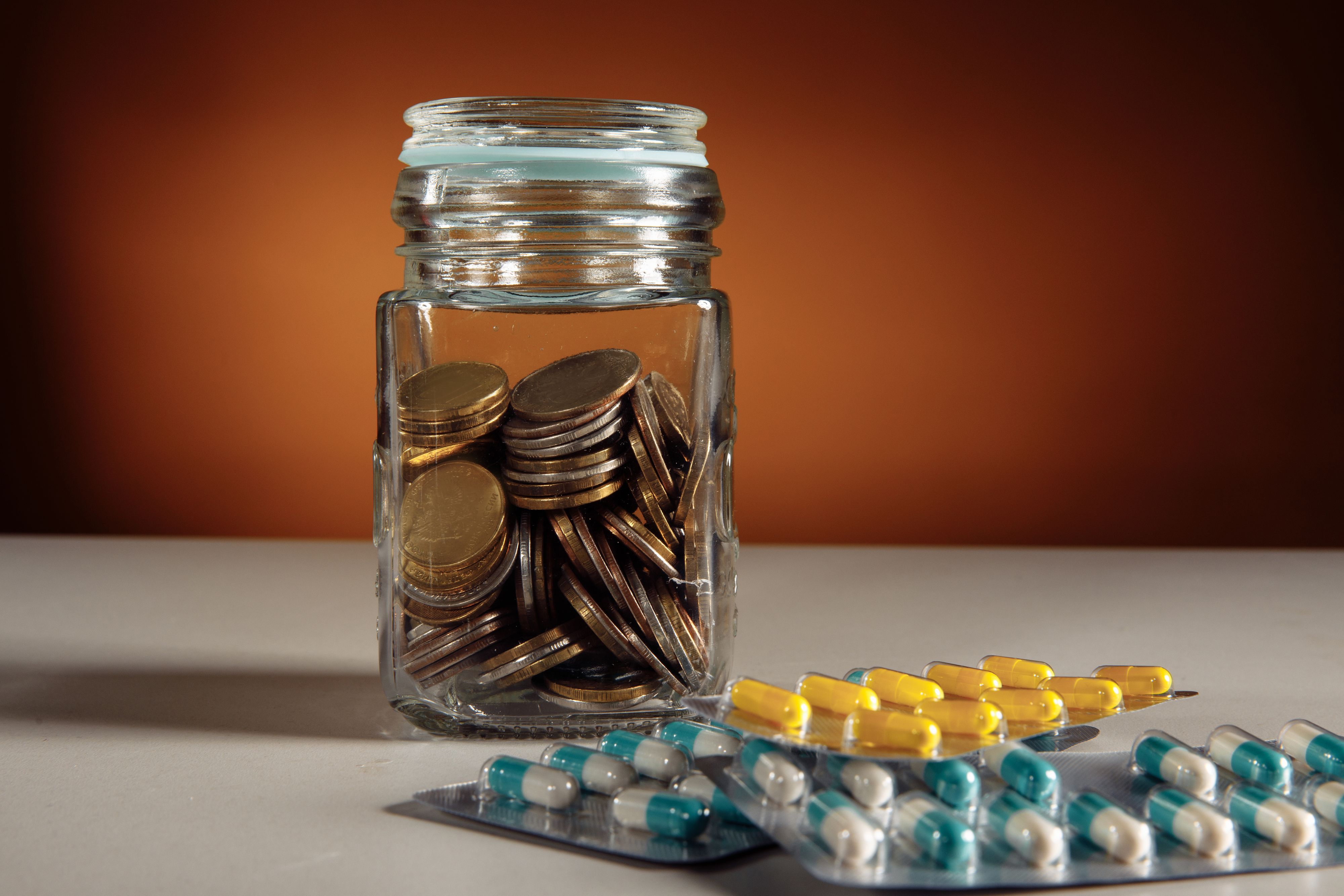 Image of medications and savings jar. Prescription Savings Plan
