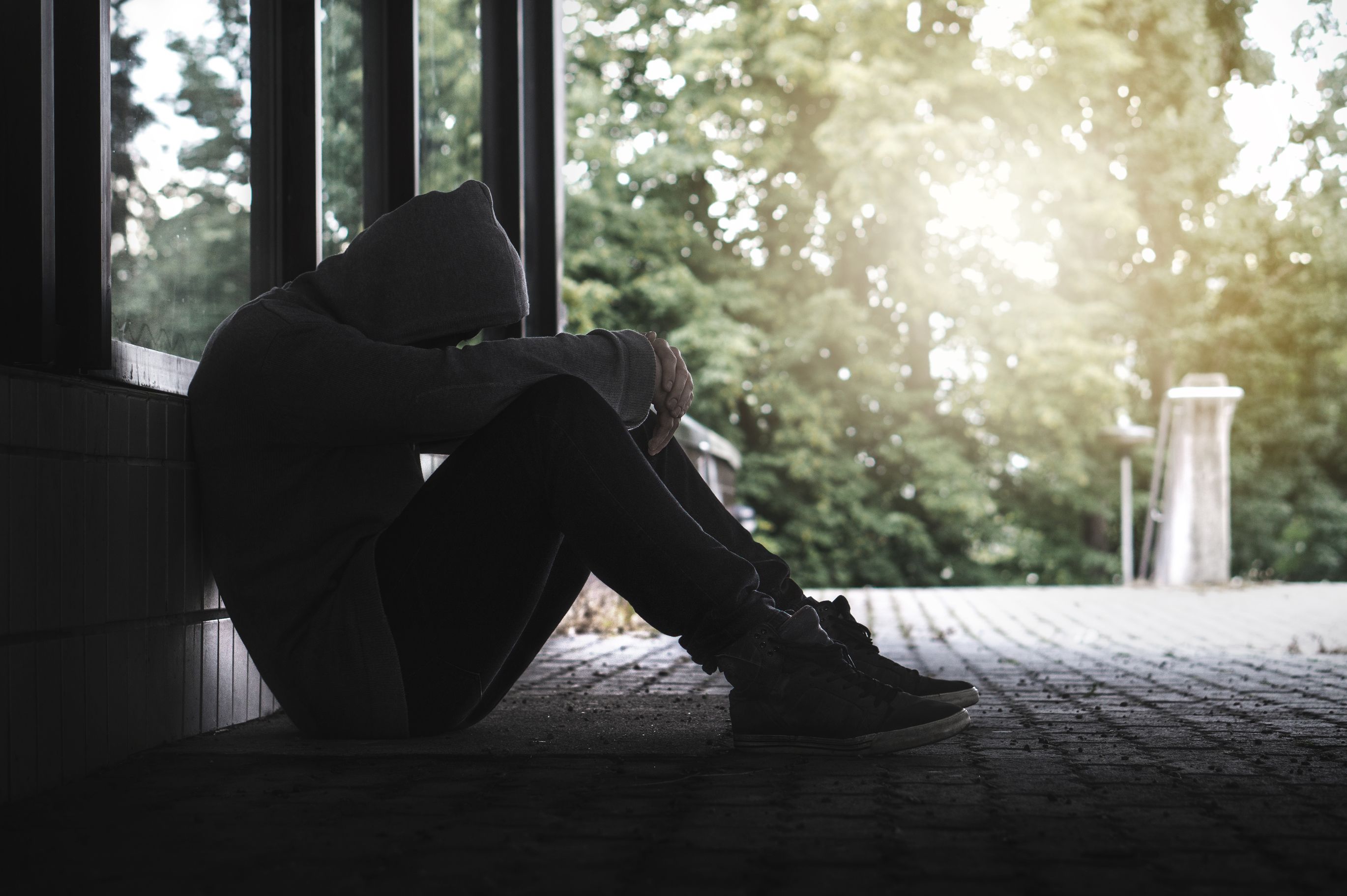Man sitting on the ground with his head down Mental Health