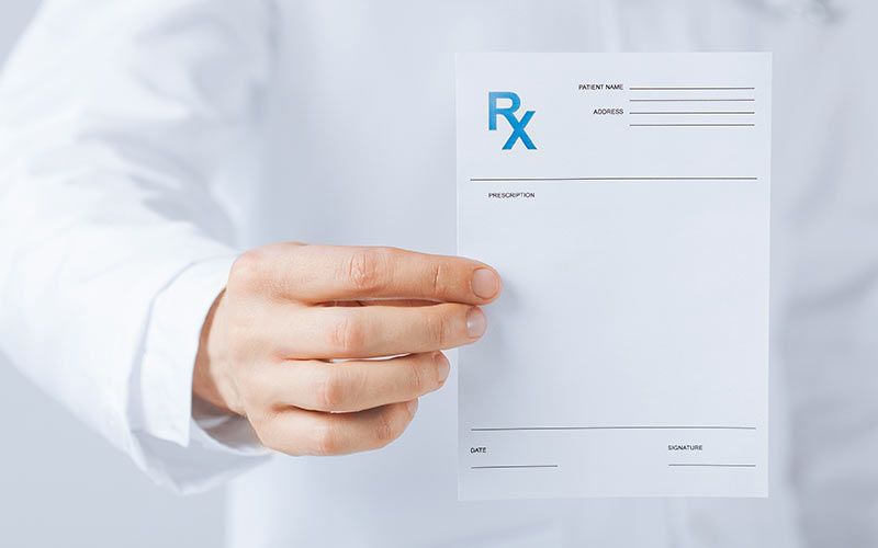Pharmacist handing out prescription