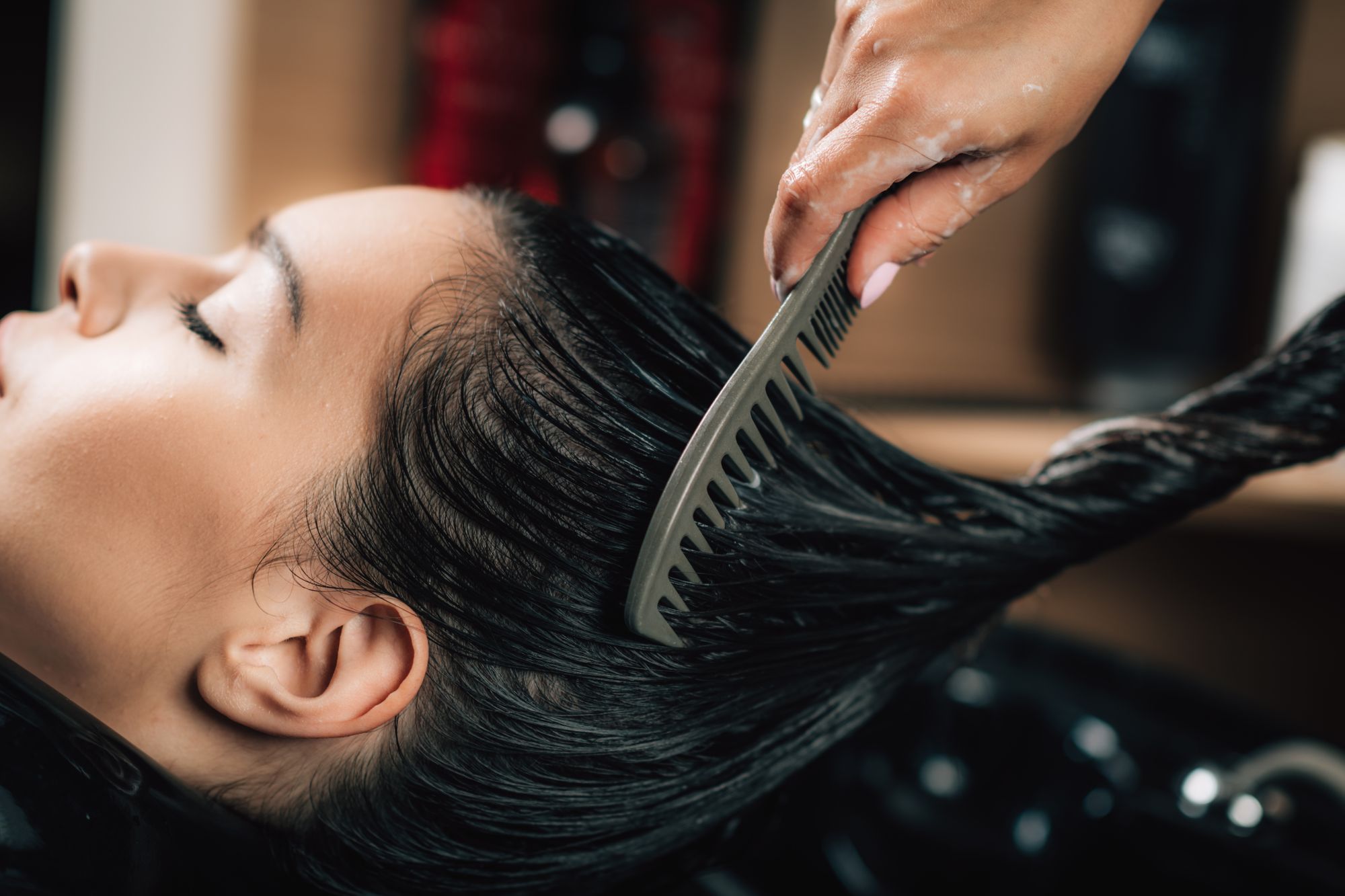 hairdresser-brushing-womans-long-black-hair-VRJ6ZW2.jpg