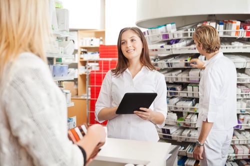 a pharmacist speaks to a patient