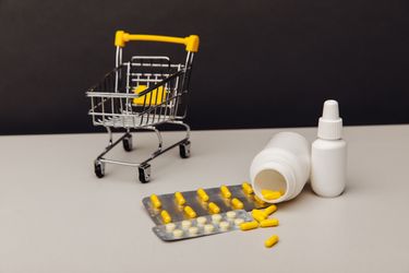 Image of medicaitions on surface with a small shopping cart Over The Counter