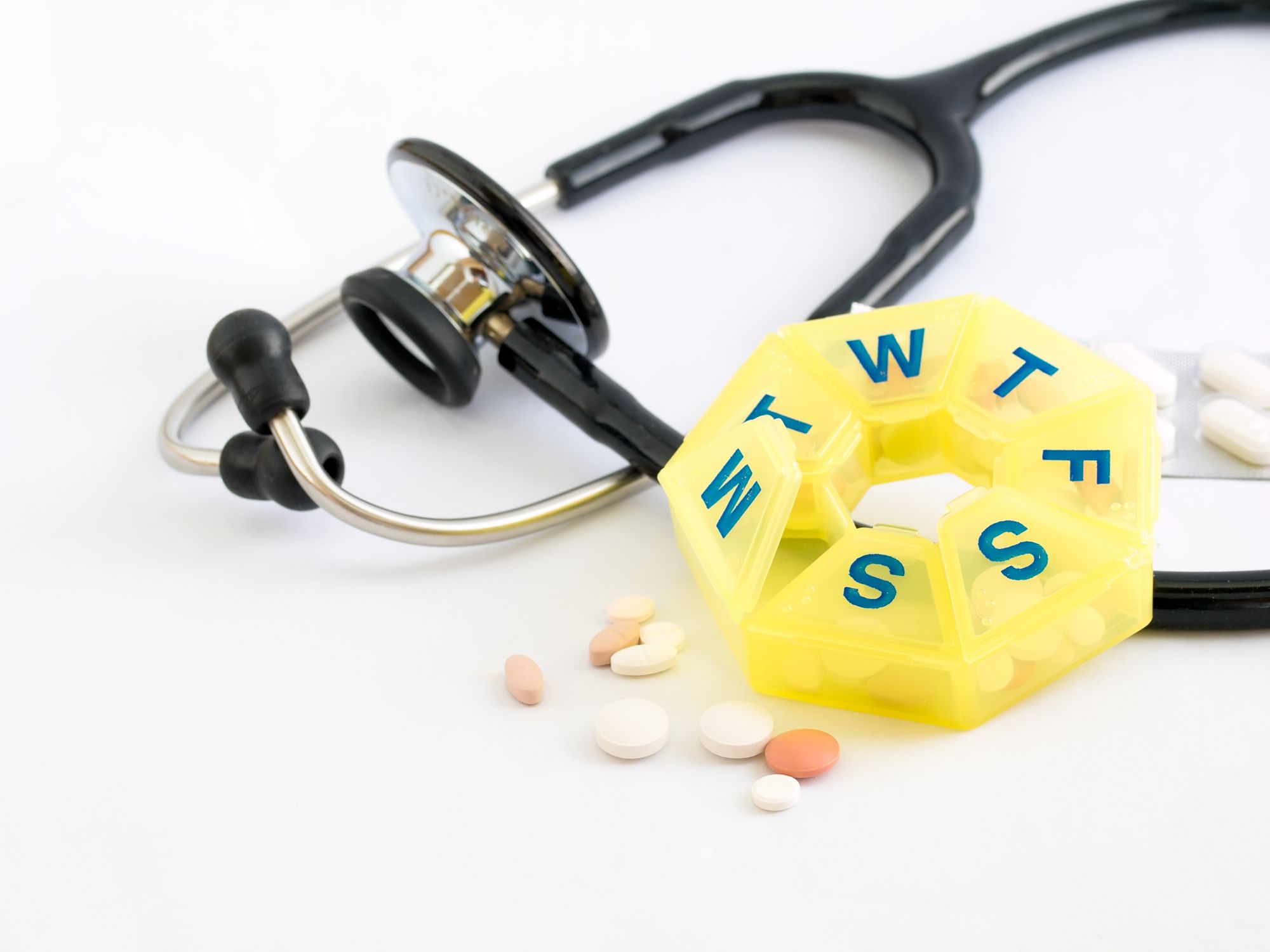 Image of a pill organizer and stethoscope Medication Adherence