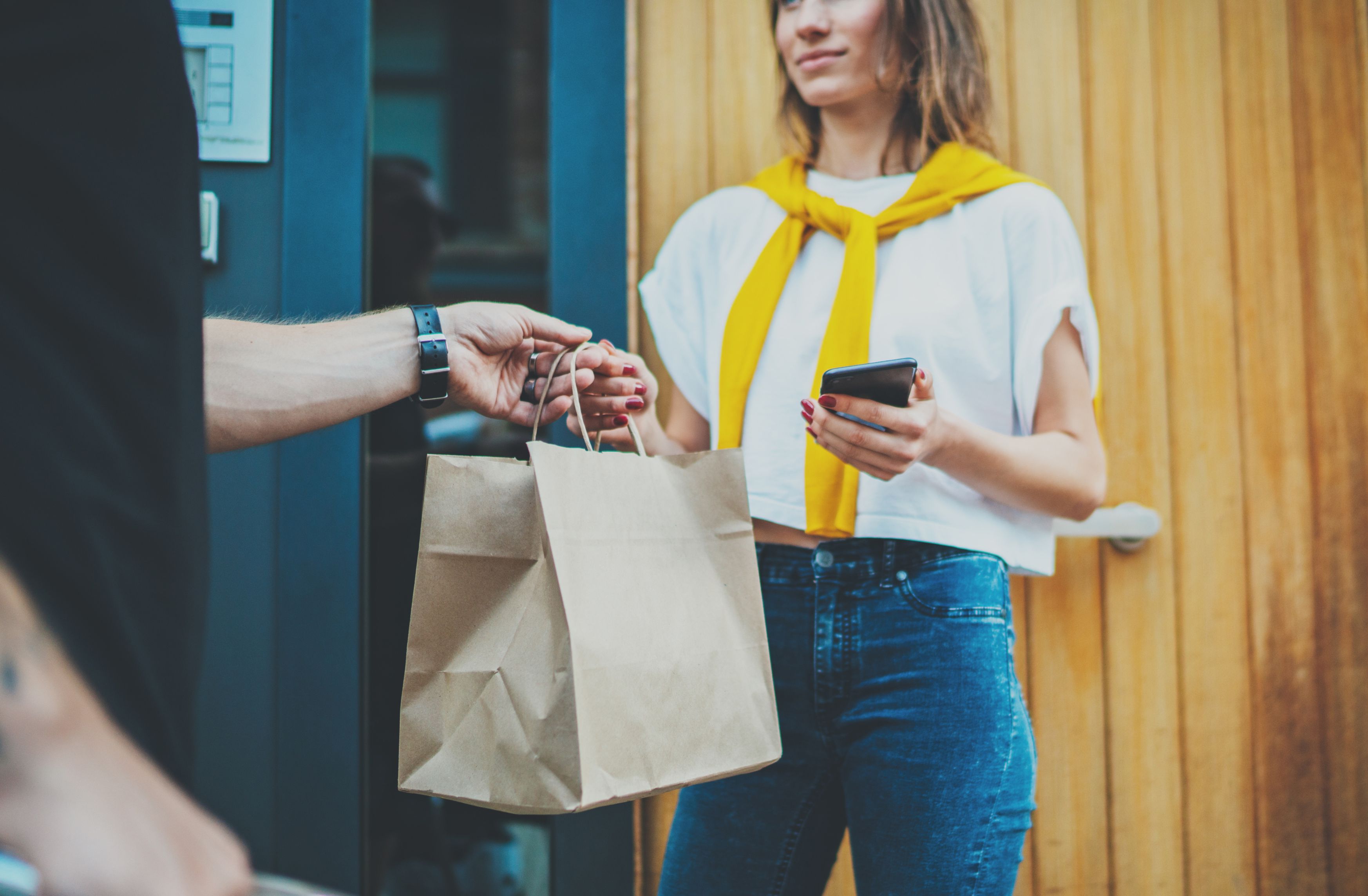 Image of a delivery guy handing out package to a woman Delivery
