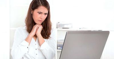 Woman looking upset at her computer