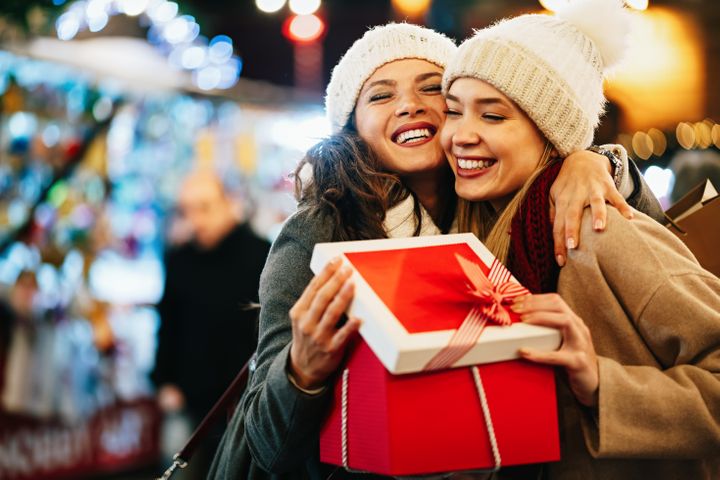 happy-women-friends-exchanging-christmas-present-2021-09-29-20-46-29-utc.jpg