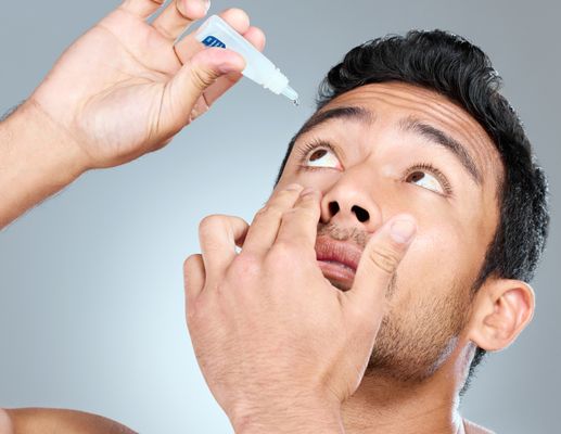 Man putting in eyedrops compoudning