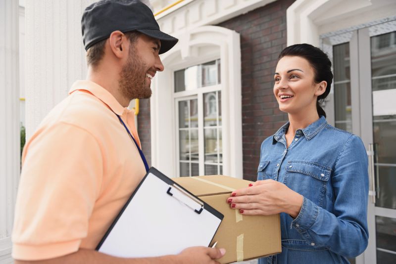A delivery person hands off a package Home delivery