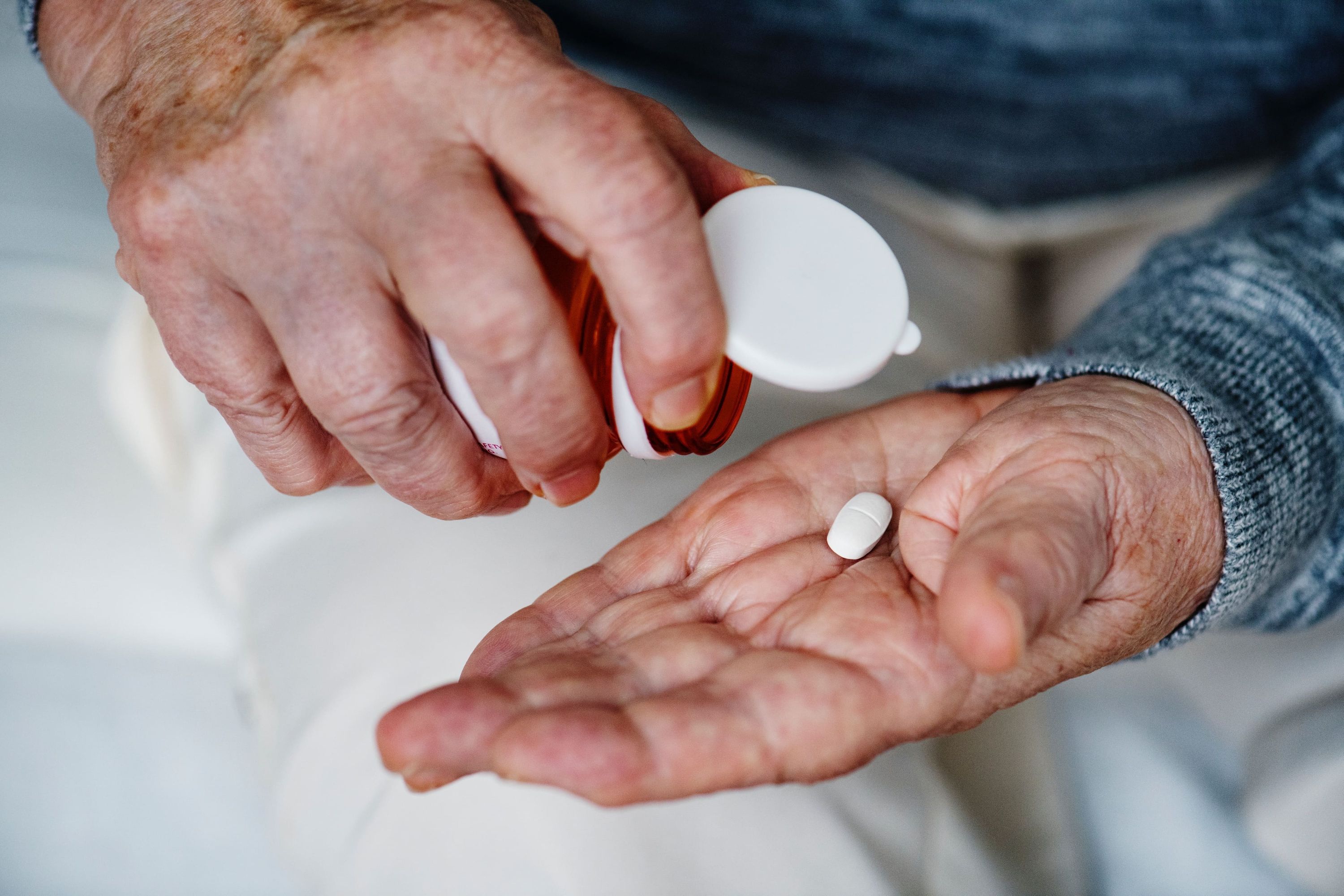 Elderly man with pill bottle