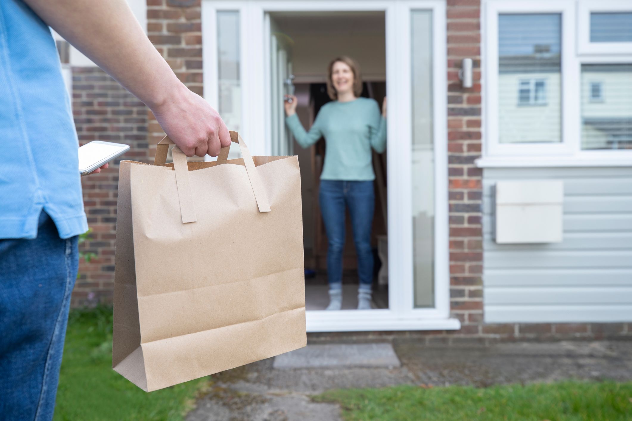 Image of a delivery guy handing out package Free Delivery