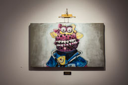 Acrylic, finger paint, gems, charcoal & house paint on found board, painting light, wall label, 2015. 2' x 3.5' Sarah Hill - DOC in a Box