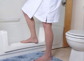 Person stepping into bathtub