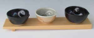 karen-hembree-pouring-bowl-trio-on-sushi-block-soda-fire-and-oxidation.jpg