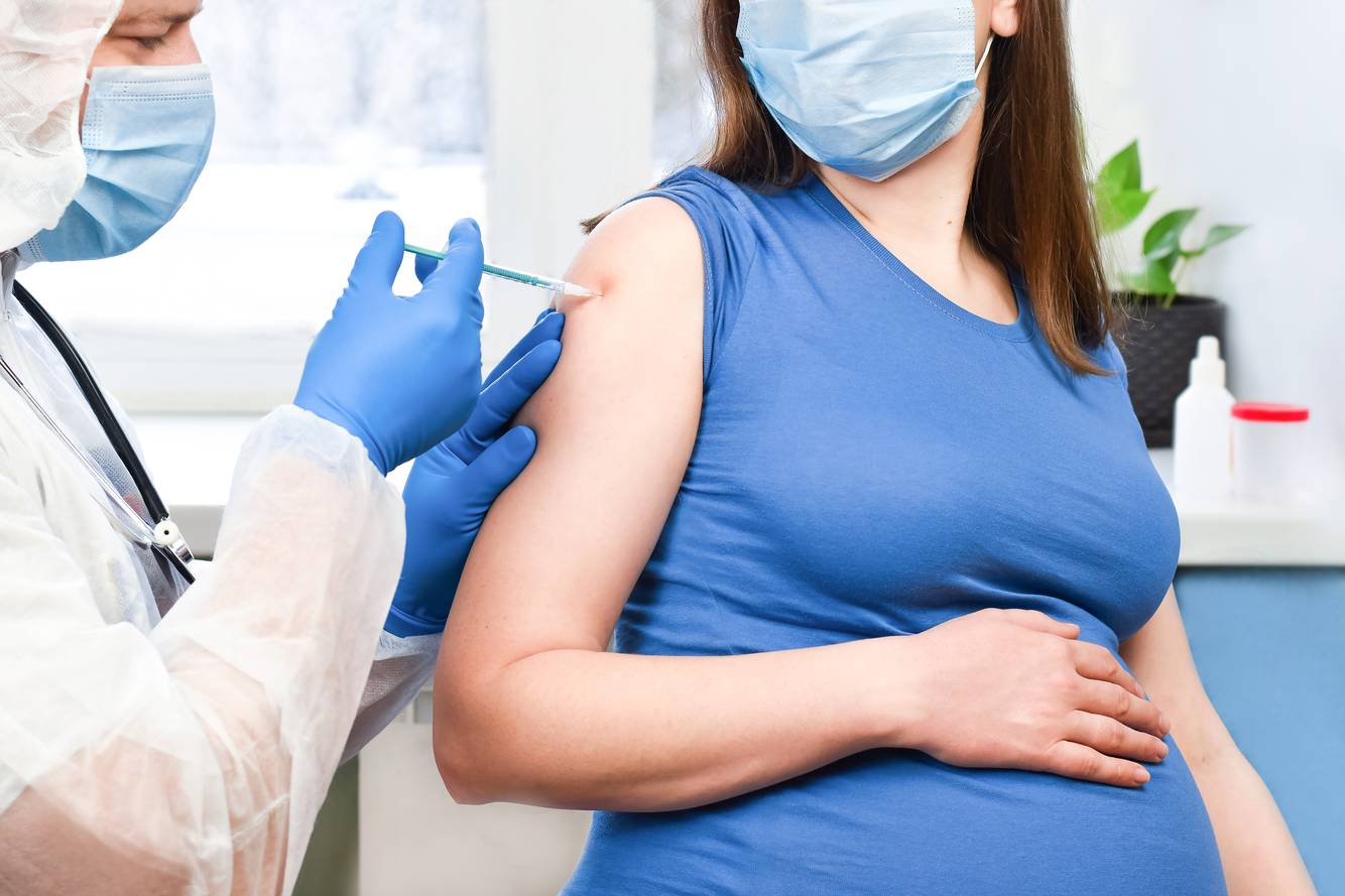 Pregnant woman receiving a vaccine Immunizations