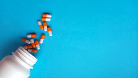 Image of medications spilled on a blue background Over The Counter