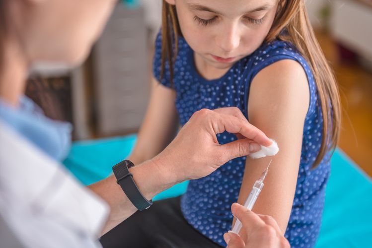 Young girl receiving a vaccine Immunizations