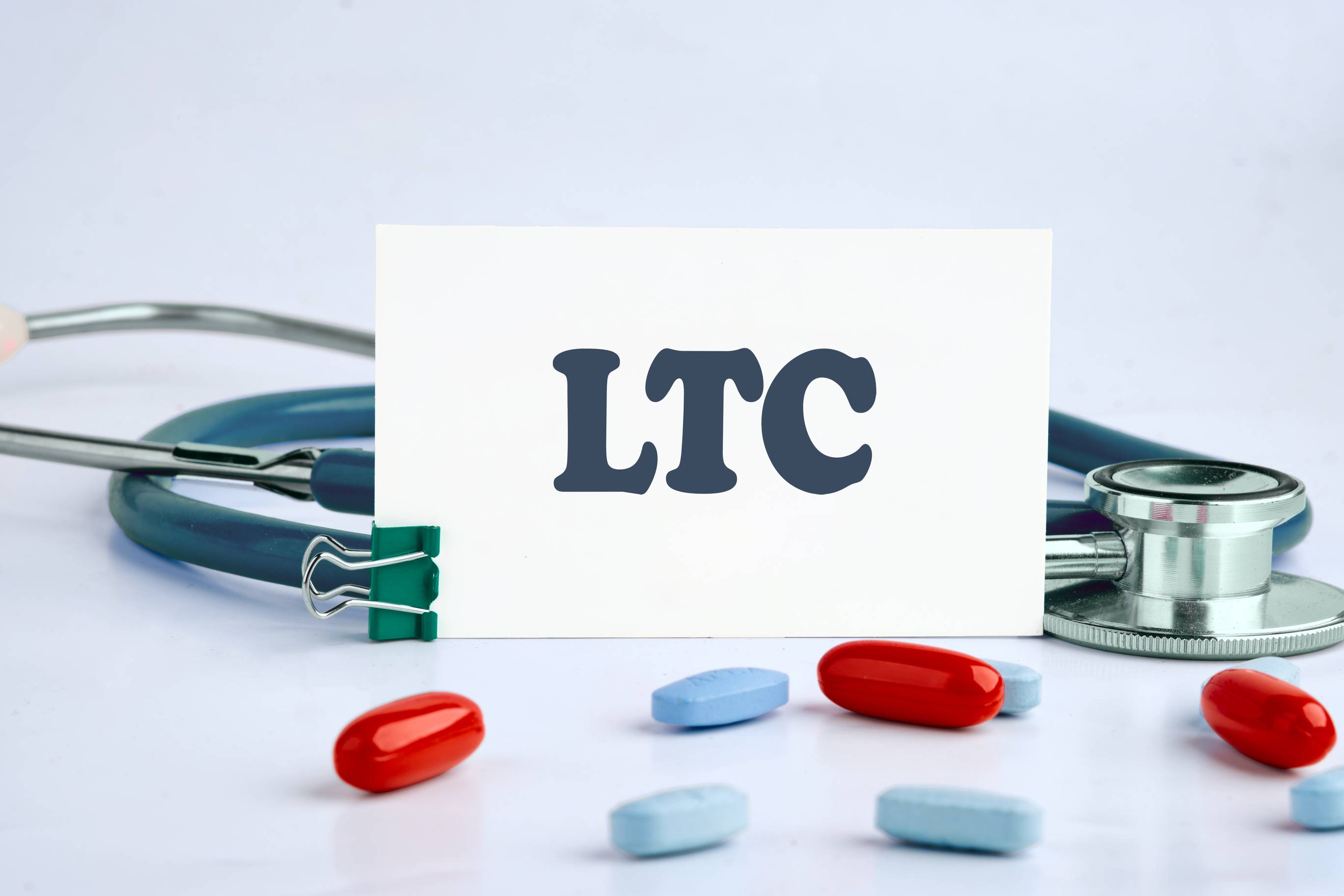 LTC sign and stethoscope with pills Long Term Care