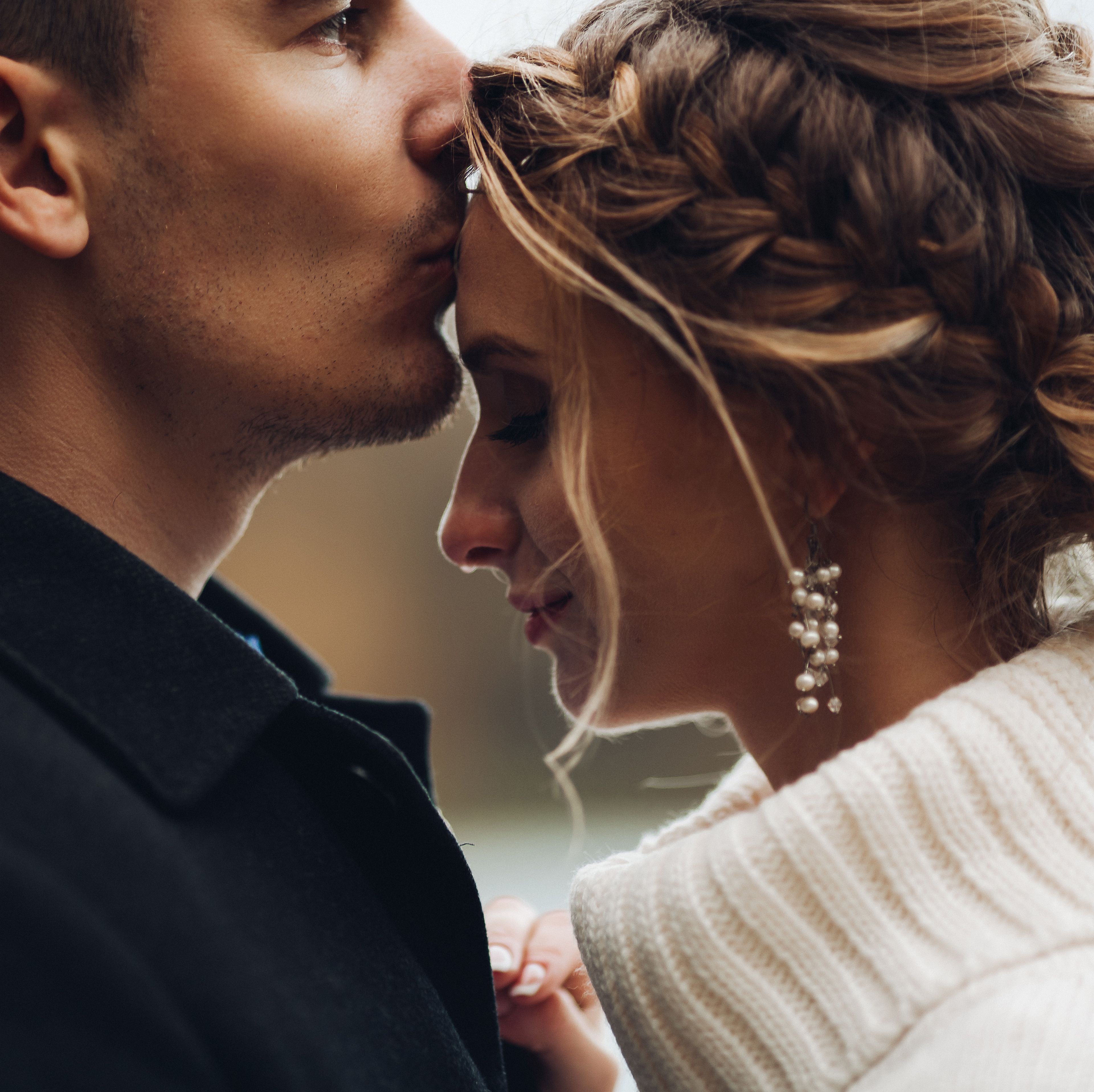 groom-kissing-beautiful-bride-in-forehead-autumn-w-BKYCPV7.jpg