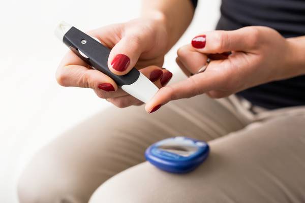 Women doing finger blood test