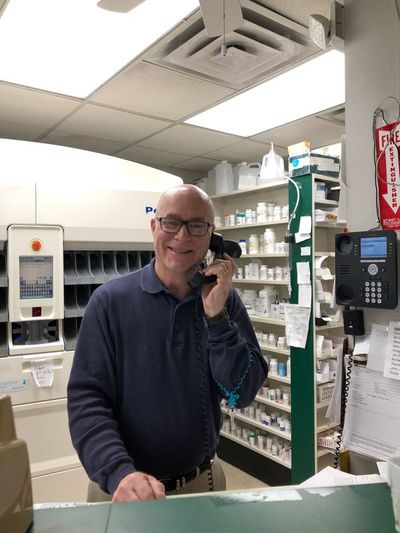 Pharmacist talking on the phone About Our Pharmacy