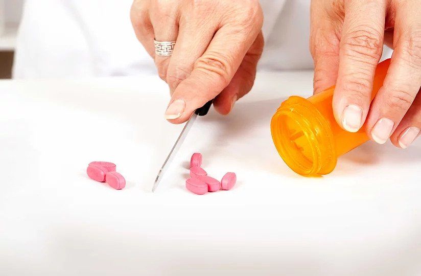 pharmacist cutting pills.jpg